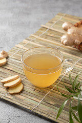 Tea in a glass cup with fresh ginger