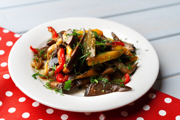 Oven baked vegetable salad on wooden background