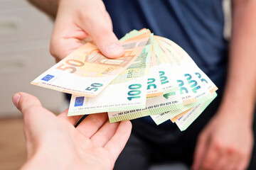 Counting money for a rent. Saving money concept. Finance, business, investment. Keeping savings at home. Spending cash for unexpected expense, unplanned losses, real estate, debts, taxes.