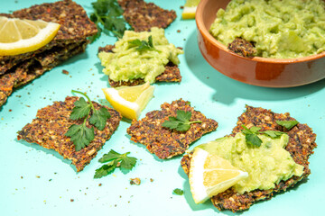 Homemade guacamole with gluten-free toast chips. Veggie appetizer guacamole, avocado paste. Healthy plant based keto diet