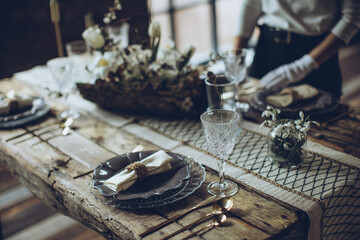 Table setting. A woman decorates the table for the holiday. High quality photo