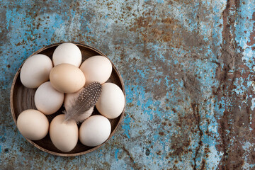 farm chicken fresh eggs from free range on a rough background. Conceptual farm products and organic products, rural and healthy dairy products Copy space or blank space for text