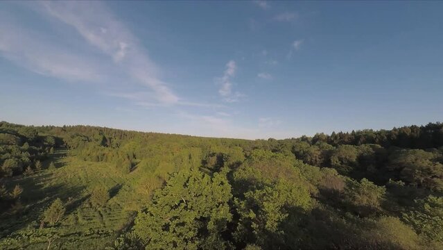 Flying over the bridge and the river on a drone. Flying along the railway rails. Flight at sunset. A sunny summer day. Aerial photography . FPV flights. High-speed flights on a drone.