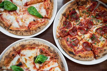 Top view three delicious Italian pizzas on the table.