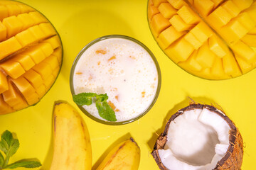 Refreshing yogurt, milkshakes or smoothies. Three glasses with fruit milkshakes. White banana, green apple avocado, yellow mango tropical fruits smoothie. On bright yellow table, copy space