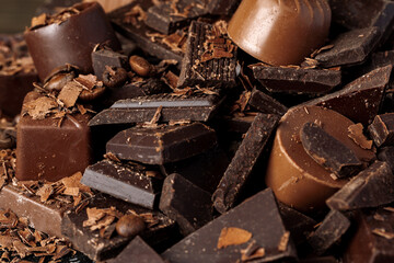 Grated chocolate and pieces of tasty chocolate on table
