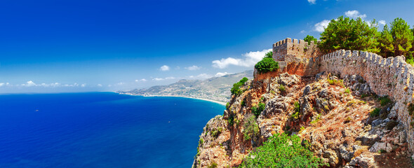Beautiful sea panorama landscape of Alanya Castle in Antalya district, Turkey, Asia. Famous tourist destination with high mountains. Summer bright day and sea shore - obrazy, fototapety, plakaty