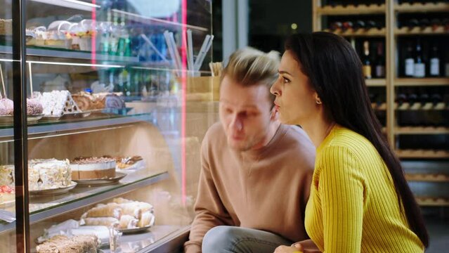 Good Looking Couple In The Coffee Shop Looking At The Showcase Fridge Woman Very Excited Showing To Her Man What Dessert She Find