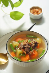 a bowl of beef and vegetables soup 