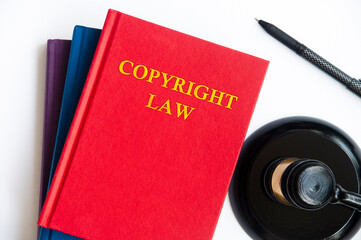 Top view of Copyright Law book with gavel on white background