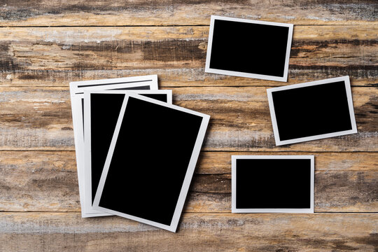 Blank photo frames for your photos on wooden background