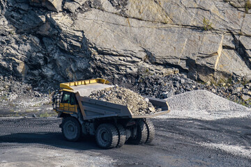Dump truck in limestone mining, heavy machinery. Mining in the quarry.