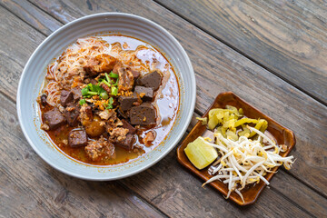 Rice Vermicelli noodles with pork spicy soup or Thai name is Khanom Jeen Nam Ngeow the favorite delicious famous food of Chiang Mai, Northern of Thailand.