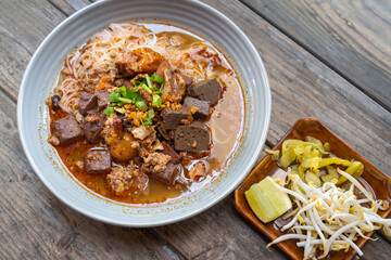 Rice Vermicelli noodles with pork spicy soup or Thai name is Khanom Jeen Nam Ngeow the favorite delicious famous food of Chiang Mai, Northern of Thailand.
