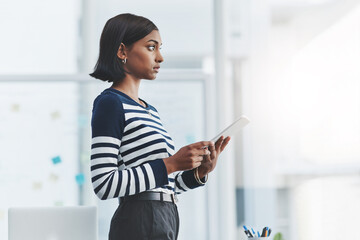 Focus and discipline govern how far you get in life. Shot of a young businesswoman holding a...