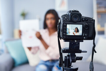 Helping others learn how to apply make up by vlogging. Cropped shot of an attractive young woman working at home.