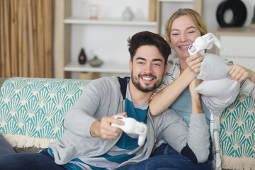 happy couple playing video games at home