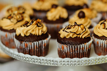 Cupcakes with butter cream stand on the candy bar