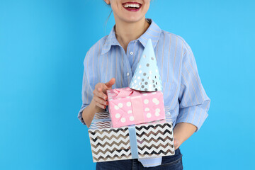 Concept of Happy Birthday with young woman on blue background