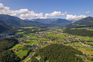 Naklejka na ściany i meble Aerial view of the village, fields and forest in mountains Alps Austria