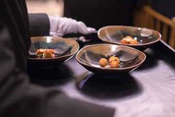 waitress serve food on tray to guest