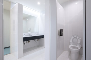 View of public toilet with basin and mirror