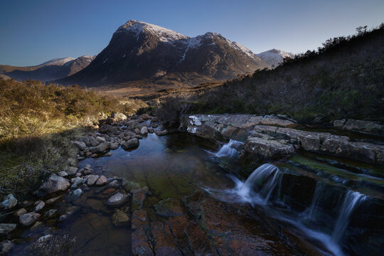 Devils staircase waterfall located on the west highland way, Glencoe, Highlands Scotland with mountain views.
