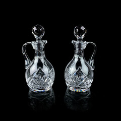 antique glass decanter with geometric pattern. retro decanter for alcohol on a black isolated...