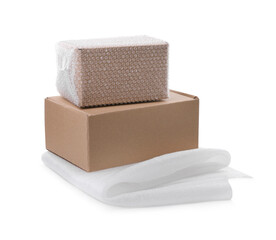 Cardboard boxes with bubble wrap and packaging foam on white background