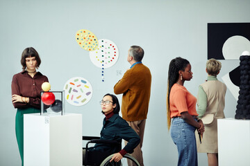 Group of diverse multi-ethnic people looking at various contemporary art objects at exhibition in modern museum - obrazy, fototapety, plakaty