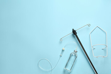IV infusion set on light blue background, flat lay. Space for text