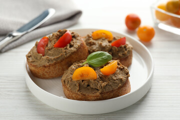 Slices of fresh bread with delicious pate and tomatoes on white wooden table, closeup
