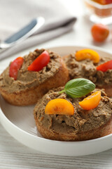 Slices of fresh bread with delicious pate and tomatoes on white wooden table, closeup