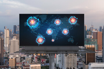 Glowing hologram of Earth planet map on billboard over aerial panoramic cityscape of Kuala Lumpur at sunset, Malaysia, Asia. The concept of international business in KL.