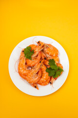 boiled fresh shrimps with parsley on white small dish