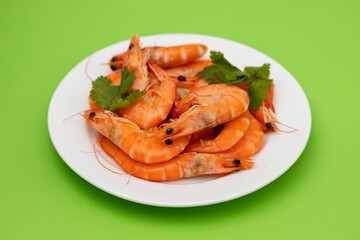 boiled fresh shrimps with parsley on white small dish