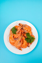 boiled fresh shrimps with parsley on white small dish