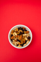 dry fruits in white small bowl on red paper