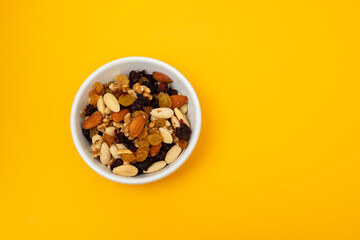 dry fruits in white small bowl on yellow