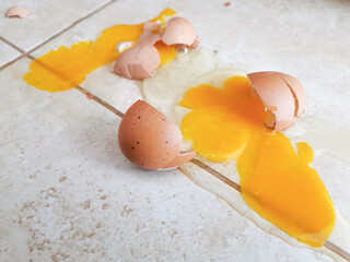 Broken eggs on the floor. Photo can be used for the concept of how to clean up broken eggs. 