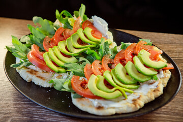 tomato avocado and basil on pita bread with cream cheese