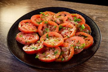 appetizer of fresh tomatoes with spices, herbs and olive oil