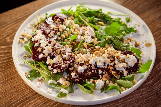 beetroot with cheese on a pillow of arugula and the addition of walnut crumbs