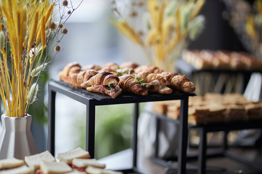 crispy croissants on a black stone plate. sweet croissants on black plate, party catering