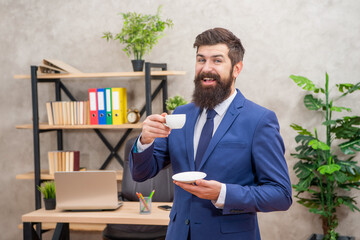 happy mature entrepreneur in jacket having coffee break at office, coffee break