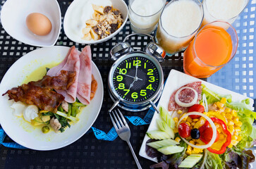 Selective of Alarm clock with intermittent fasting during breakfast with a healthy food concept for diet plan image