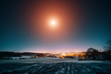 night winter landscape with starry sky and UFO