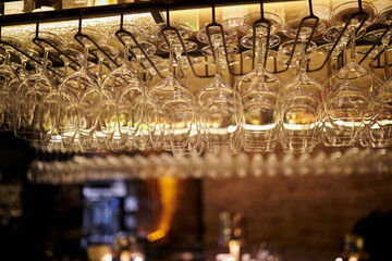 Empty wine glasses over the bar. many empty wine glasses over the bar.