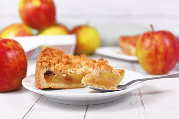 Naklejka na ściany i meble Piece of traditional European apple pie with topping crumbles called 'Streusel' on dessert spoon