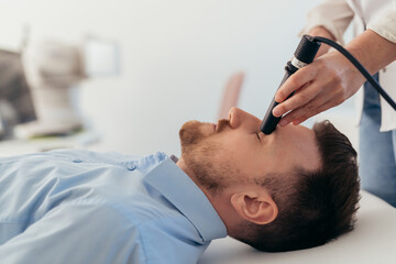 Obraz na płótnie Canvas man has eyesight examination at clinic with ultrasound scanner